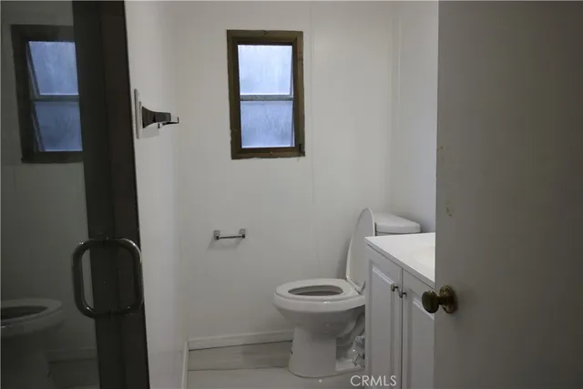 a white toilet sitting next to a bathroom sink