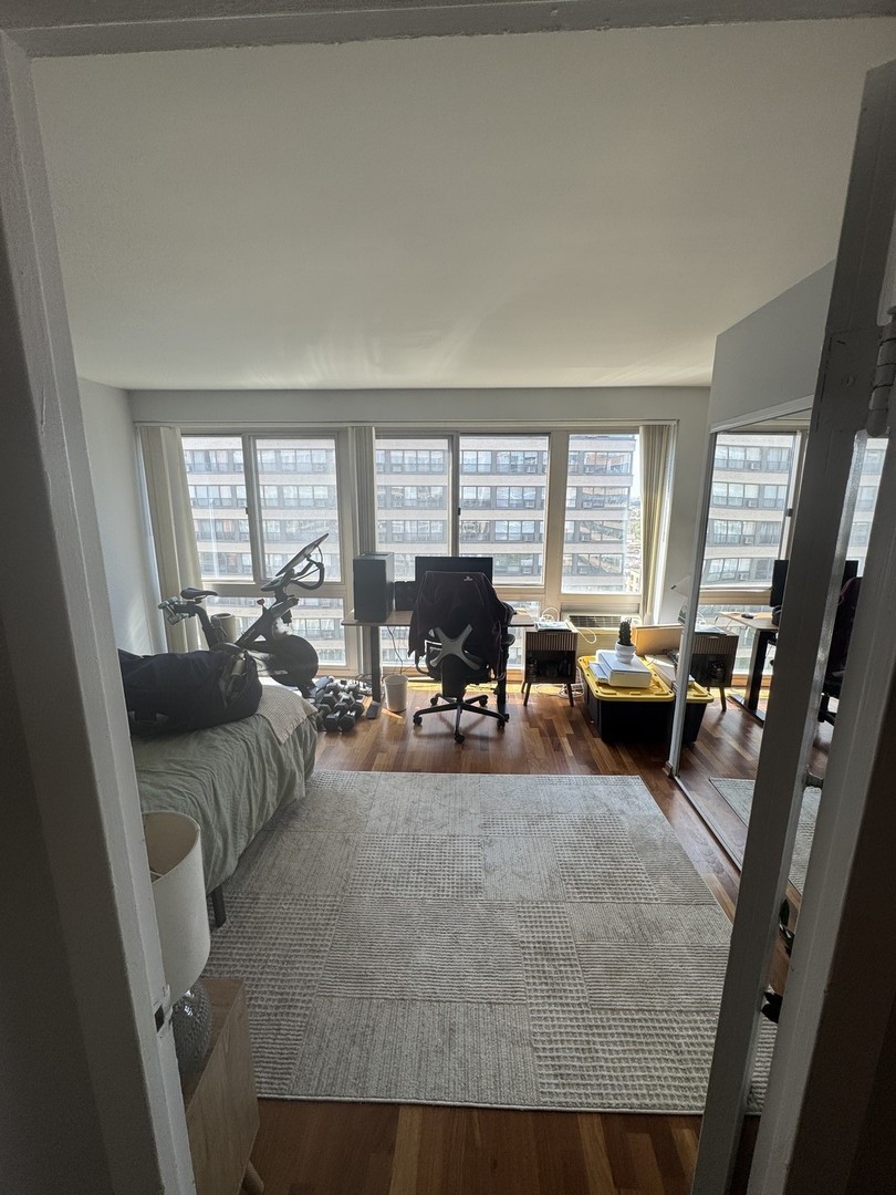 2933 North Sheridan Road, Unit 1201 Chicago, IL 60657 - Photo 11 of 16 a living room with furniture and a large window