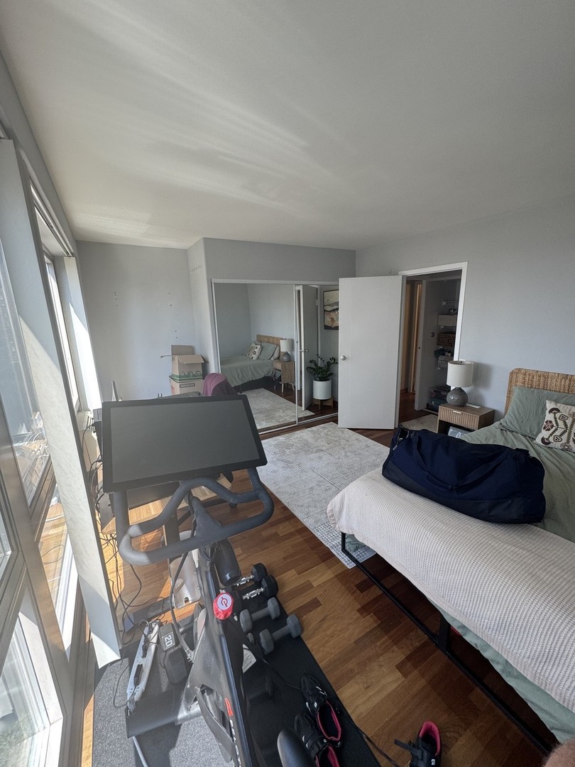 2933 North Sheridan Road, Unit 1201 Chicago, IL 60657 - Photo 12 of 16 a living room with furniture and a flat screen tv