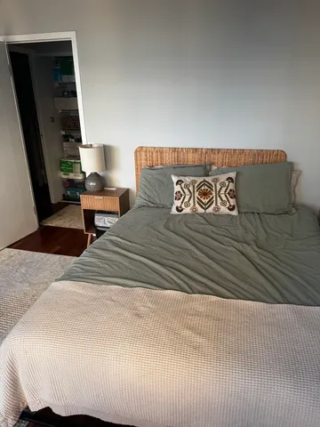 a bedroom with a bed and a chair