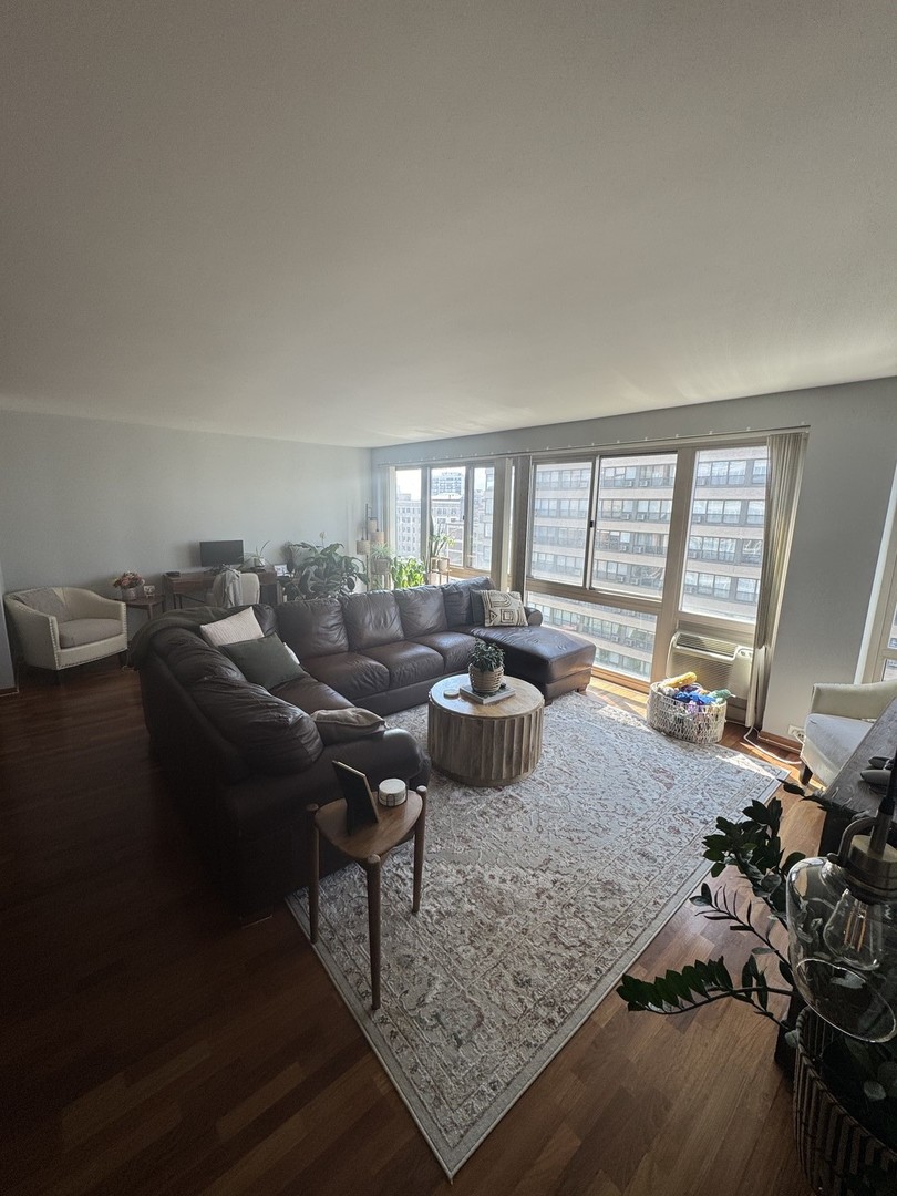 2933 North Sheridan Road, Unit 1201 Chicago, IL 60657 - Photo 2 of 16 a living room with furniture and a floor to ceiling window