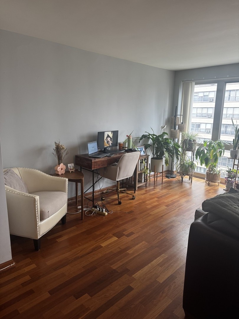 2933 North Sheridan Road, Unit 1201 Chicago, IL 60657 - Photo 5 of 16 a living room with furniture and wooden floor