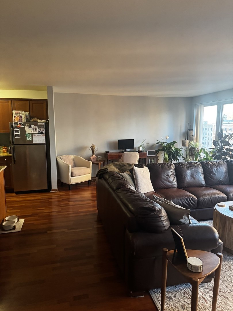 2933 North Sheridan Road, Unit 1201 Chicago, IL 60657 - Photo 6 of 16 a living room with furniture and a wooden floor