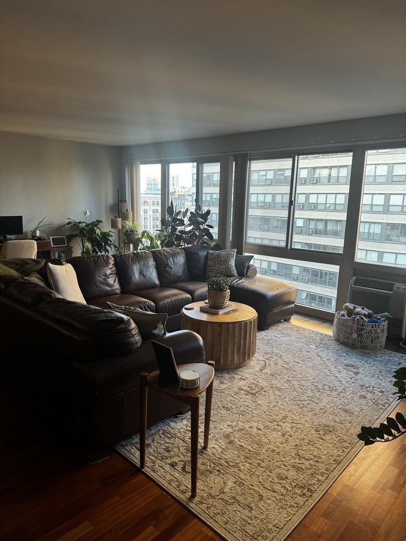 2933 North Sheridan Road, Unit 1201 Chicago, IL 60657 - Photo 7 of 16 a living room with furniture and a large window