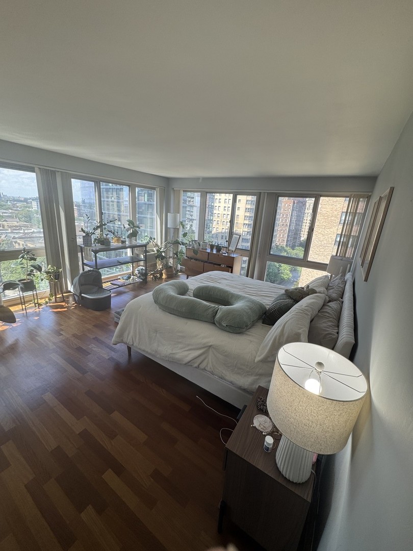 2933 North Sheridan Road, Unit 1201 Chicago, IL 60657 - Photo 8 of 16 a living room with furniture and a large window