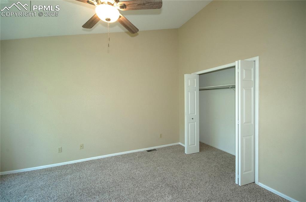3216 Capstan Way Colorado Springs, CO 80906 - Photo 18 of 45 an empty room with a chandelier fan and a chandelier fan