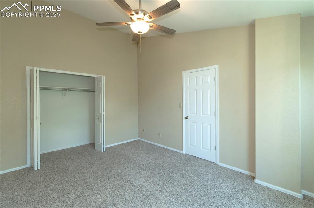 3216 Capstan Way Colorado Springs, CO 80906 - Photo 25 of 45 an empty room with a ceiling fan and a window