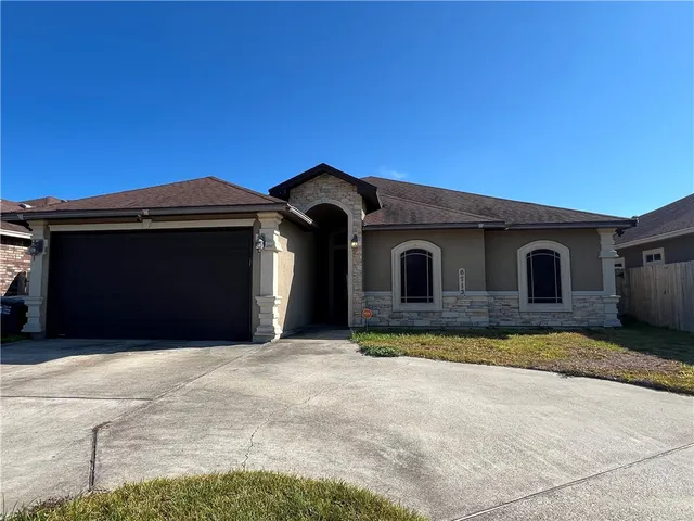 a front view of a house with a garage