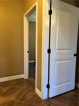 an empty room with wooden floor and closet area