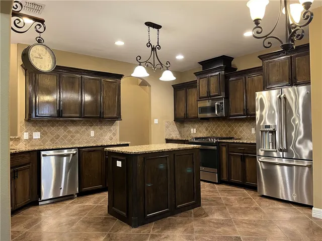 a bathroom with granite countertop double vanity and a mirror