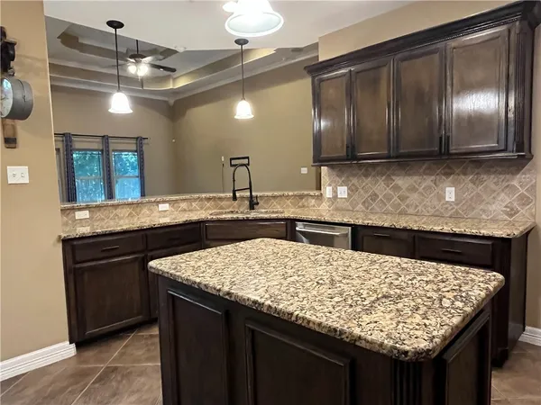 a kitchen with stainless steel appliances granite countertop a stove a refrigerator and a microwave with granite countertops