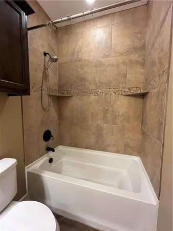a bathroom with a bathtub and a toilet