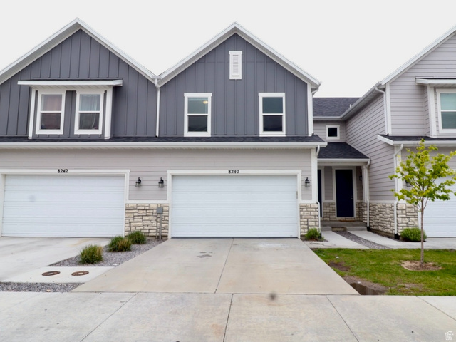8240 Cascade Vw Way Magna, UT 84044 - Photo 1 of 18 View of front facade with stone siding, board and batten siding, and a garage