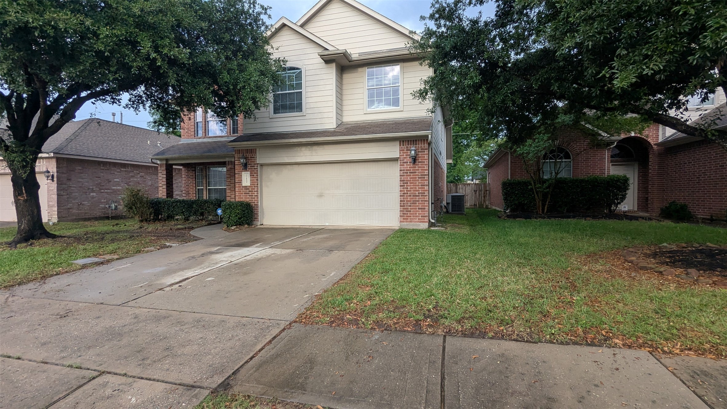 21850 Catoosa Drive Spring, TX 77388 - Photo 13 of 15 a front view of a house with a garden and trees