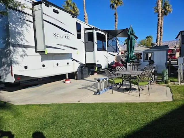 a view of a patio with a table and chairs