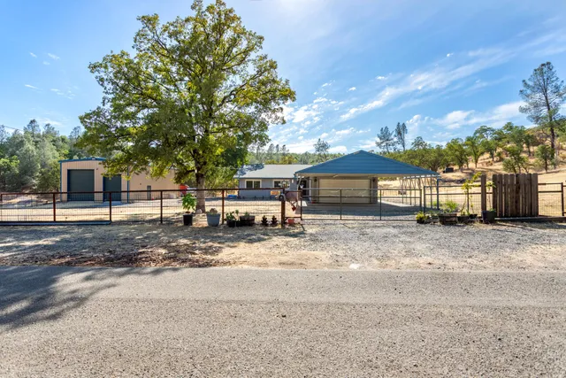 a view of a house with a yard and garage