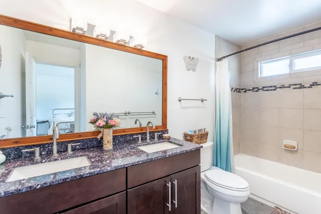 a bathroom with a sink a toilet and mirror