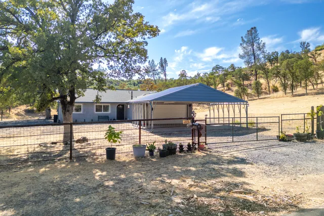 a view of a house with a yard and sitting area