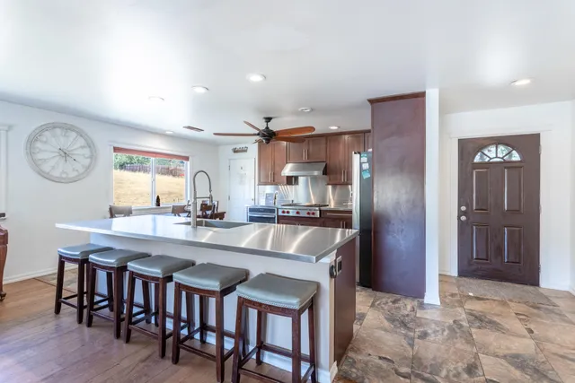 a large kitchen with a table and chairs