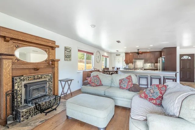 a living room with furniture a flat screen tv and a large window