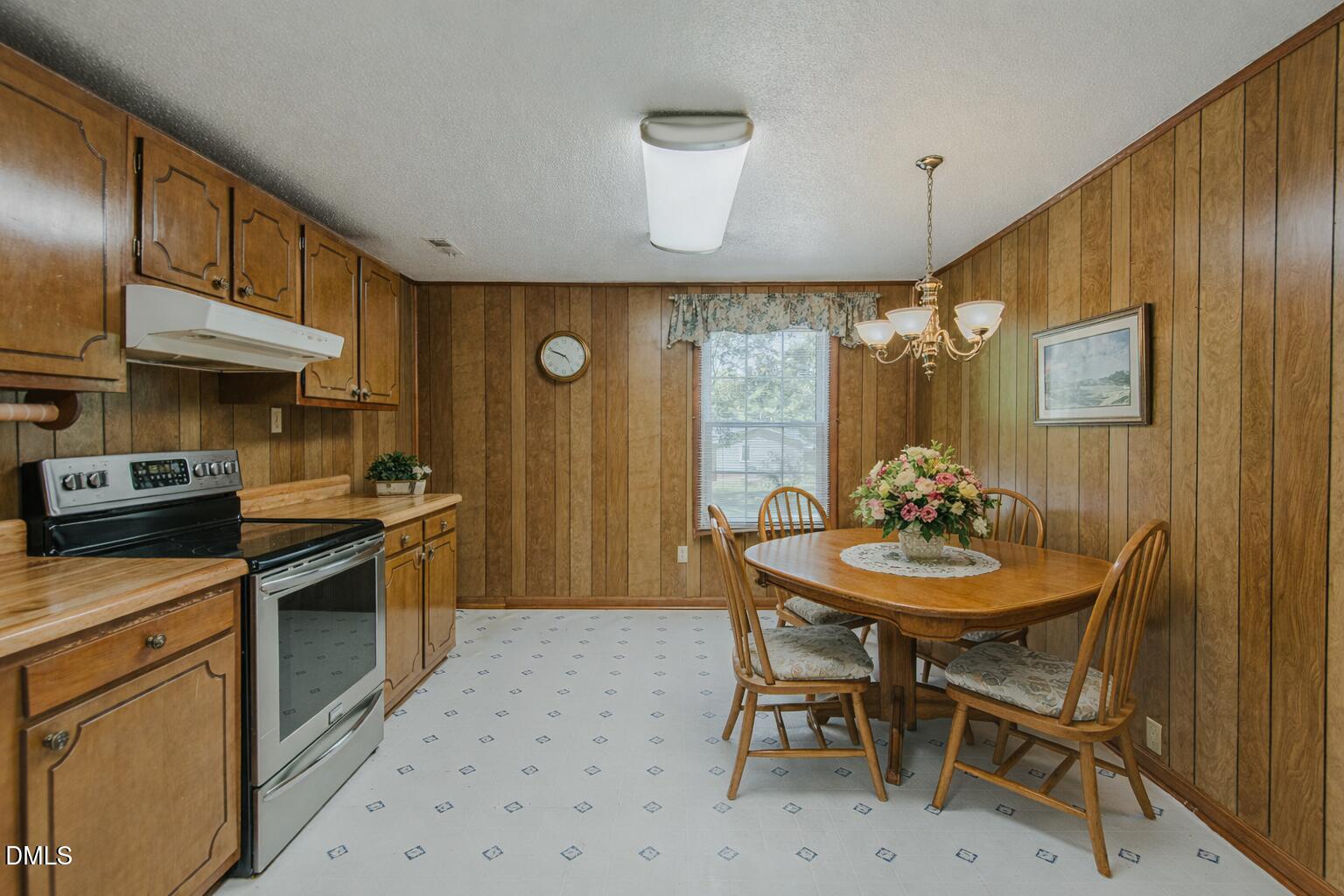 1302 Blacksmith Road Efland, NC 27243 - Photo 3 of 46 a kitchen with stainless steel appliances a sink a stove a table and chairs