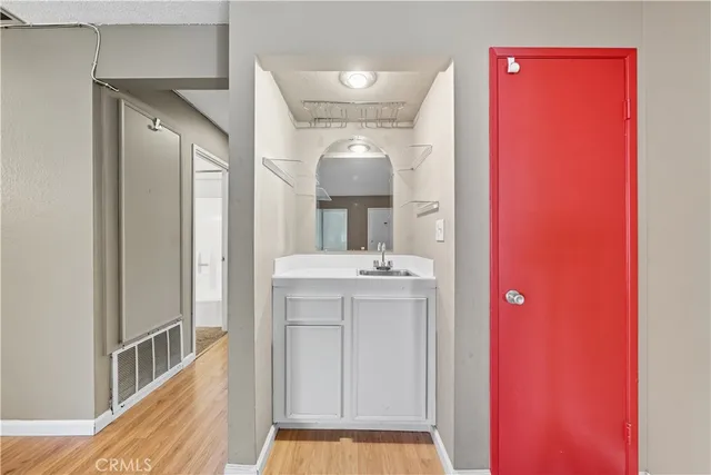 a bathroom with a sink a mirror and a vanity