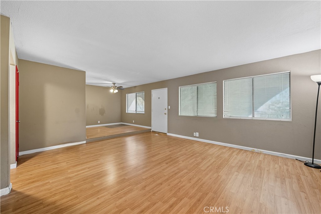 1000 Central Avenue, Unit 8 Riverside, CA 92507 - Photo 12 of 43 a view of an empty room with wooden floor and a window
