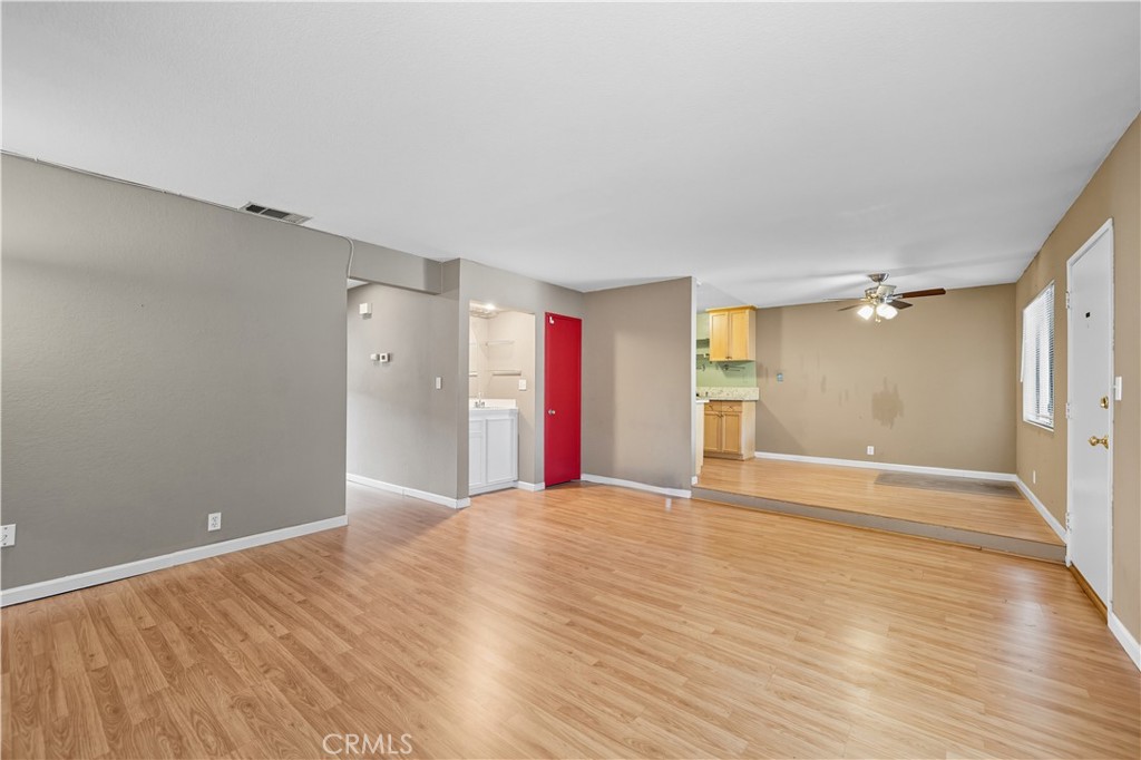 1000 Central Avenue, Unit 8 Riverside, CA 92507 - Photo 13 of 43 a view of an empty room with wooden floor and a bathroom