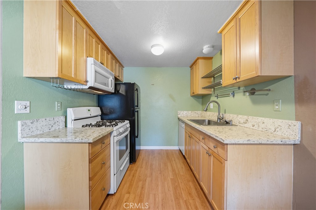1000 Central Avenue, Unit 8 Riverside, CA 92507 - Photo 17 of 43 a kitchen with a sink stove and cabinets