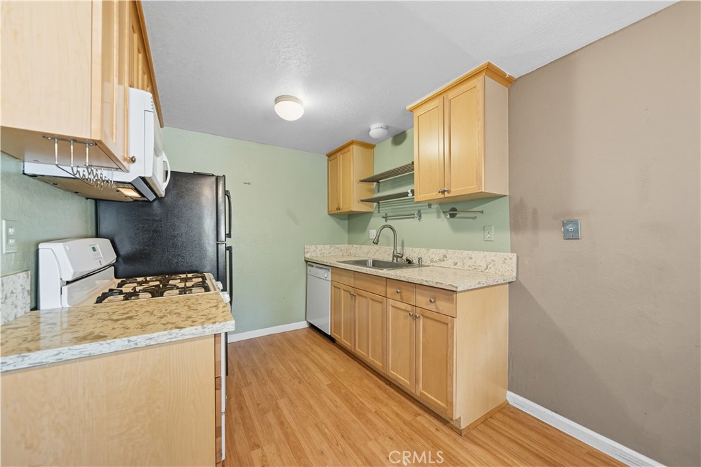 1000 Central Avenue, Unit 8 Riverside, CA 92507 - Photo 19 of 43 a kitchen with a sink stove and refrigerator
