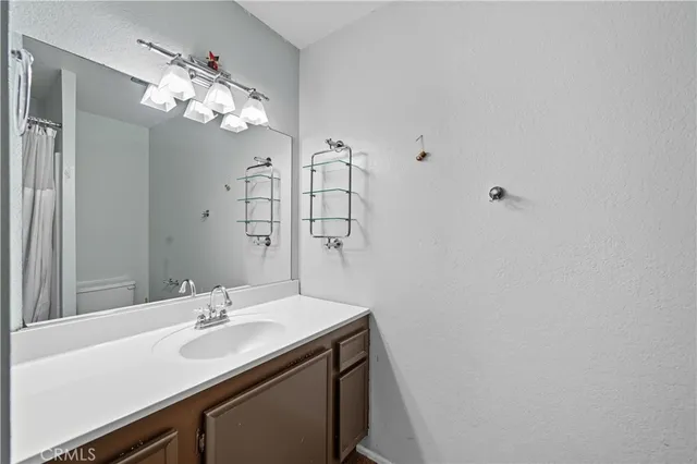 a bathroom with a sink vanity and a mirror
