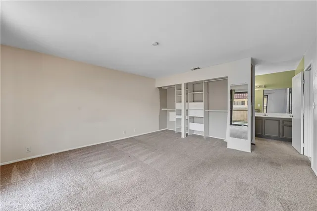 a view of an empty room with a refrigerator