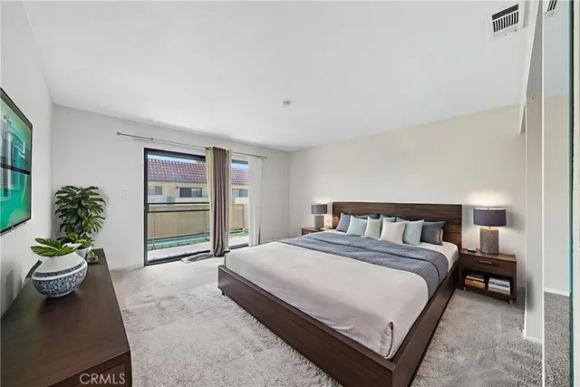 a bedroom with a bed and a couch