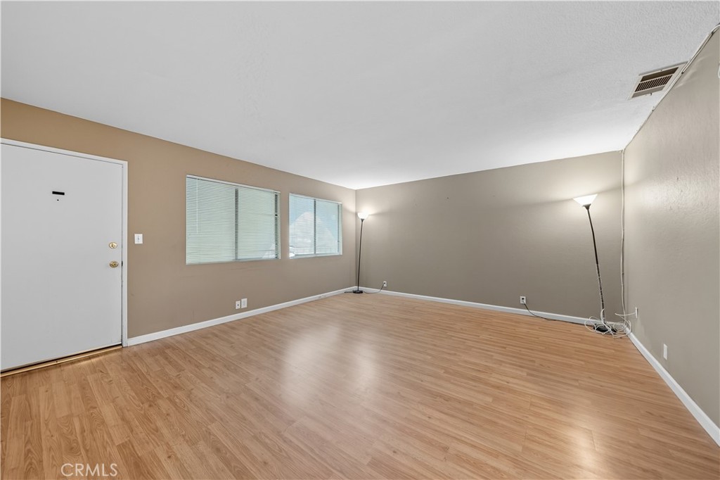 1000 Central Avenue, Unit 8 Riverside, CA 92507 - Photo 10 of 43 a view of an empty room with wooden floor and a window