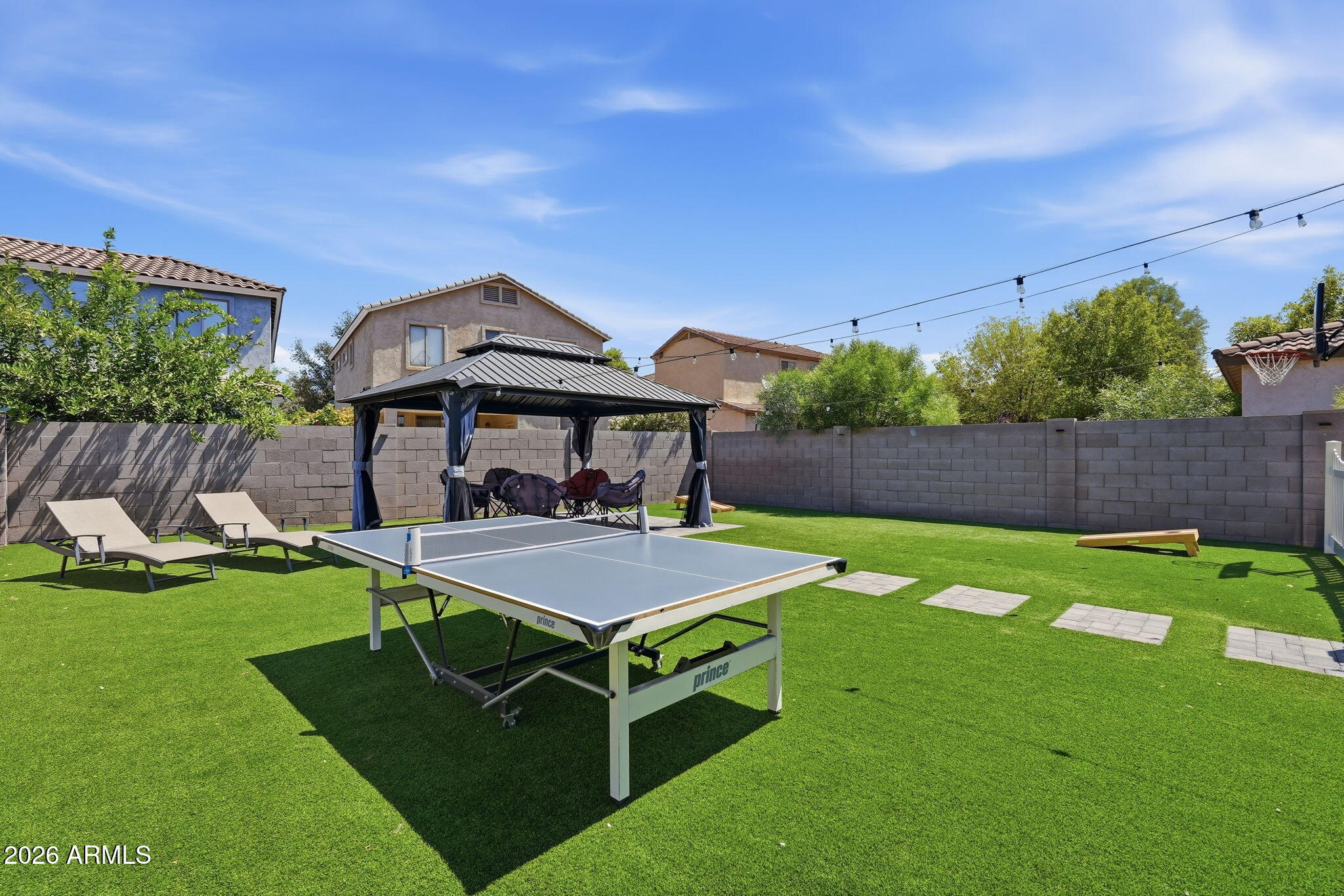 4184 East Trigger Way Gilbert, AZ 85297 - Photo 37 of 51 a backyard of a house with table and chairs