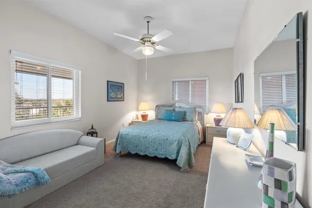 a bedroom with bed and a chandelier