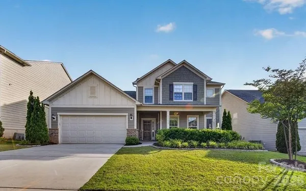 a front view of a house with a yard and garage