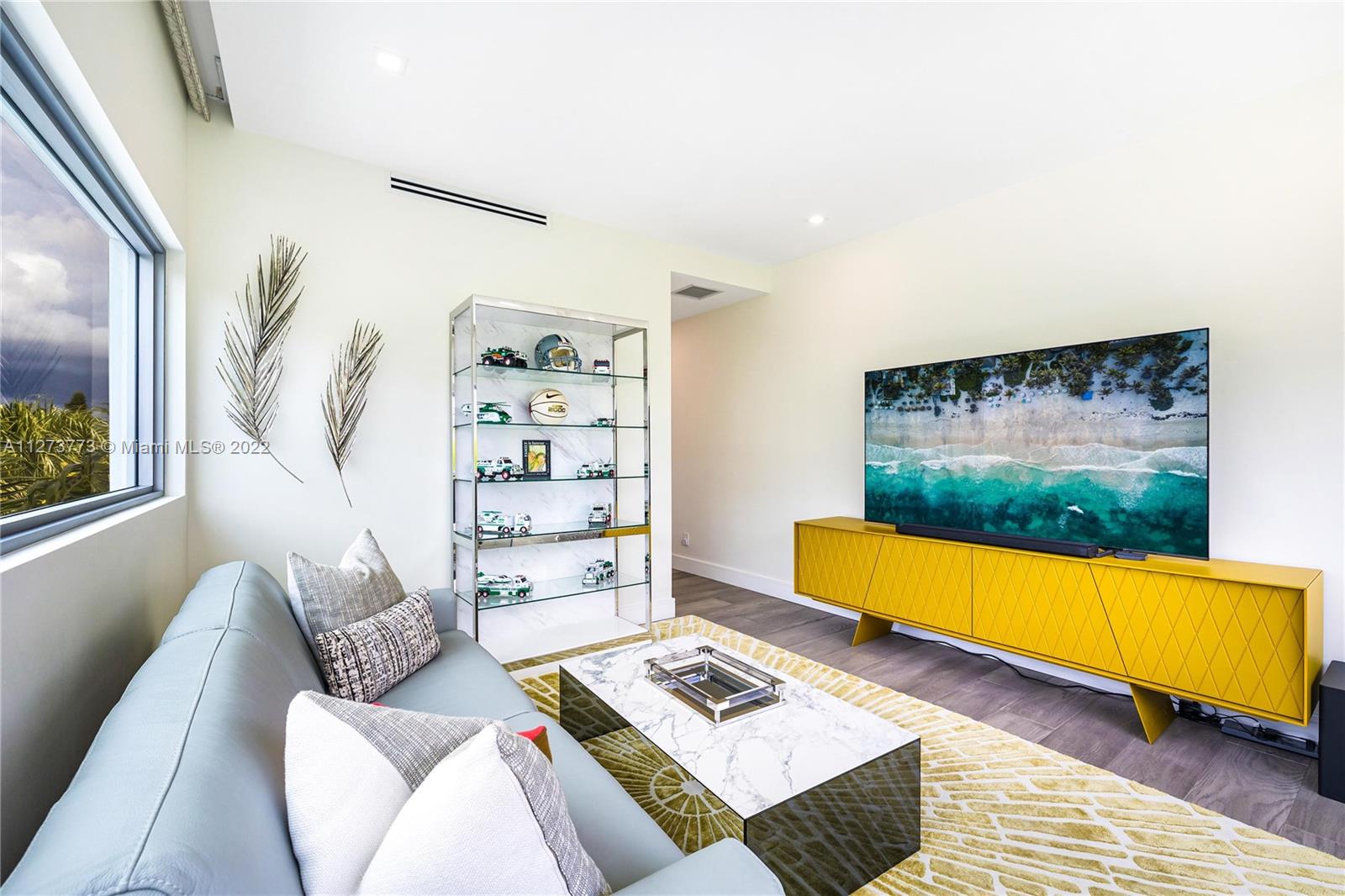 3000 Banyan Road, Unit B Boca Raton, FL 33432 - Photo 16 of 41 a living room with couch and a floor to ceiling window