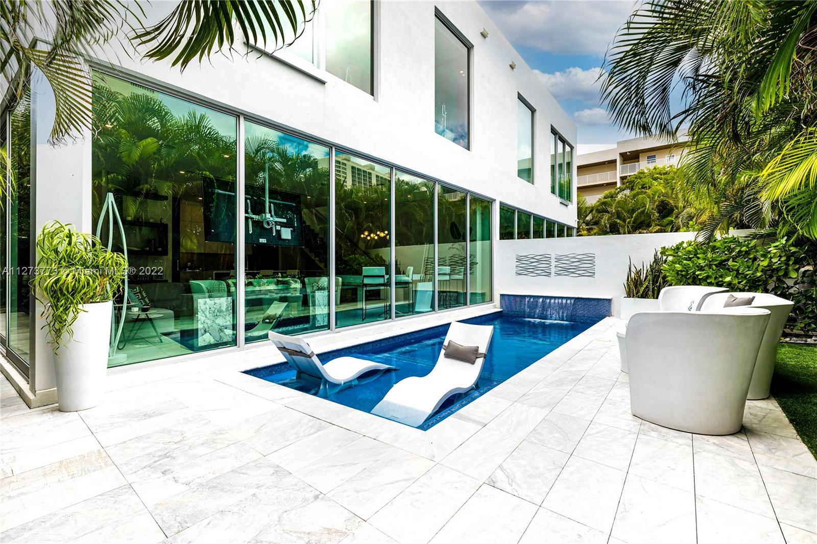 3000 Banyan Road, Unit B Boca Raton, FL 33432 - Photo 18 of 41 a view of a white building with swimming pool in front of it