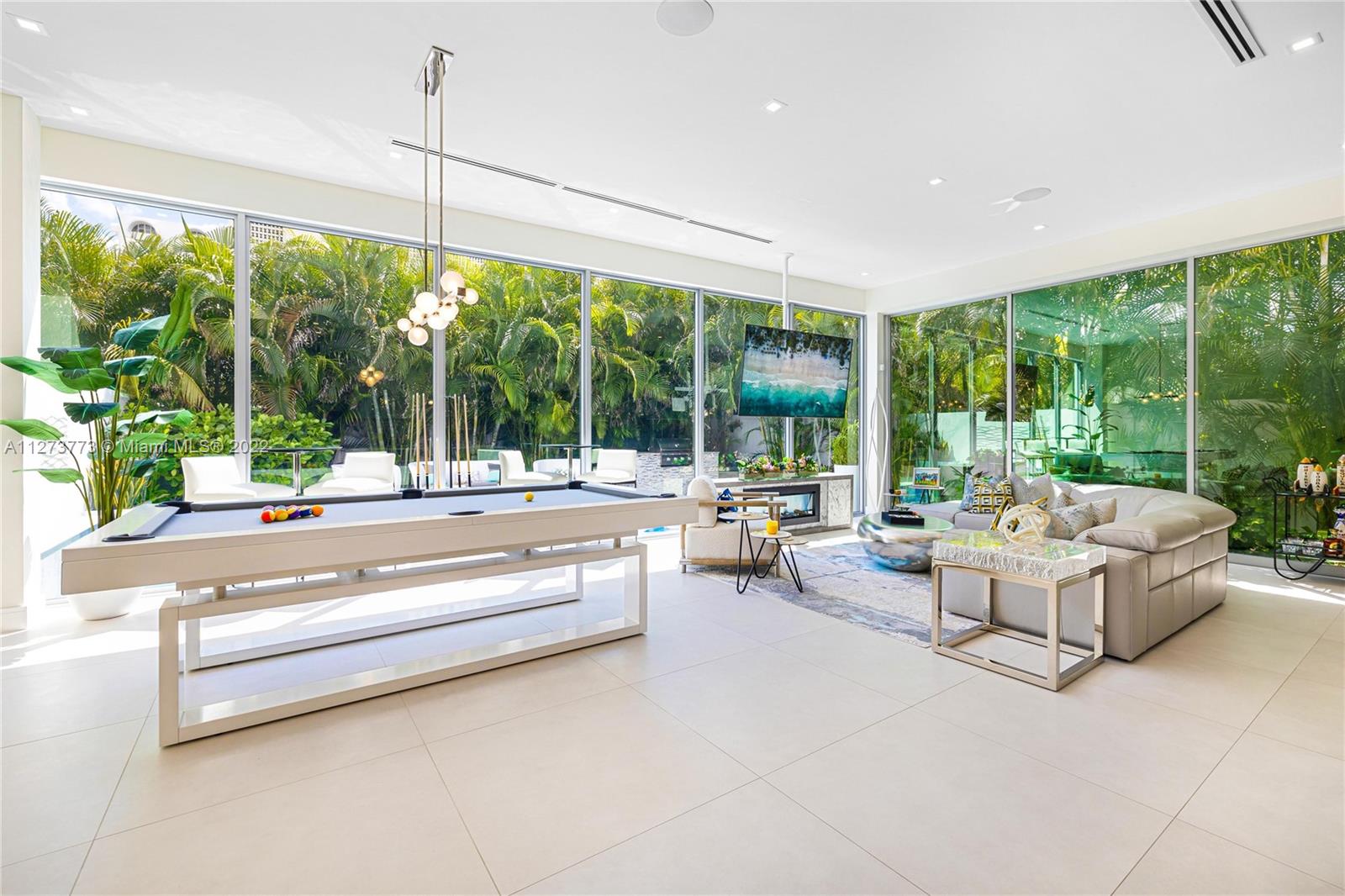 3000 Banyan Road, Unit B Boca Raton, FL 33432 - Photo 3 of 41 a living room with couch and floor to ceiling windows