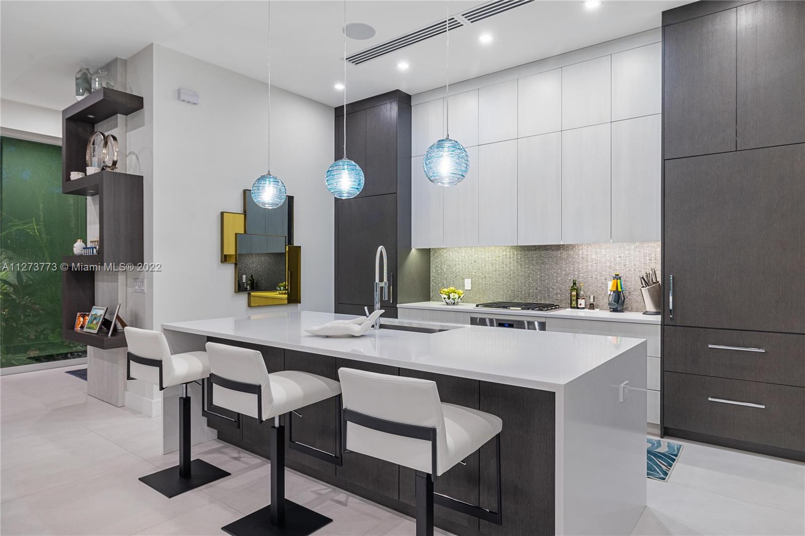 3000 Banyan Road, Unit B Boca Raton, FL 33432 - Photo 35 of 41 a kitchen with a sink cabinets and wooden floor