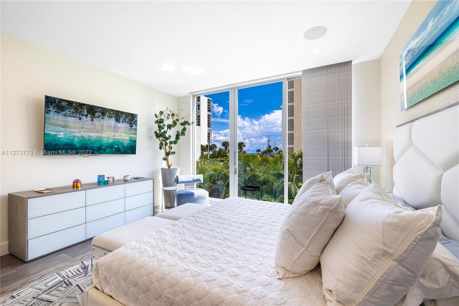 3000 Banyan Road, Unit B Boca Raton, FL 33432 - Photo 7 of 41 a bedroom with a bed and a flat screen tv