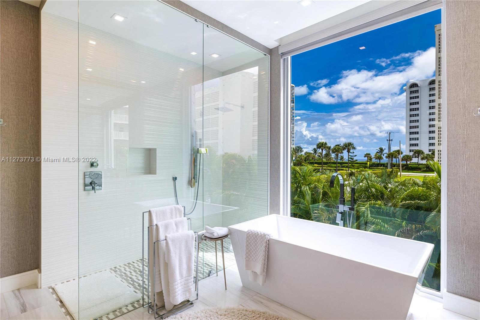 3000 Banyan Road, Unit B Boca Raton, FL 33432 - Photo 10 of 41 a bathroom with a bathtub and a large window