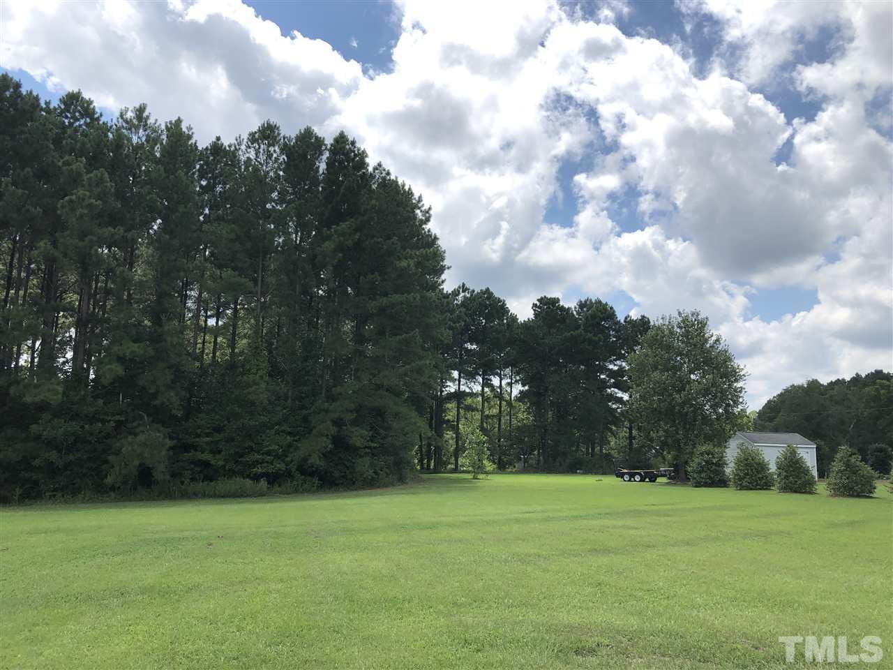 587 Rock Pillar Road Clayton, NC 27520 - Photo 2 of 12 a view of a field with trees in the background
