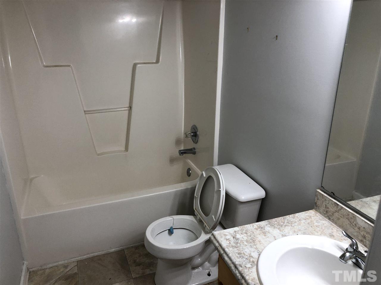 587 Rock Pillar Road Clayton, NC 27520 - Photo 11 of 12 a white toilet sitting next to a bath tub