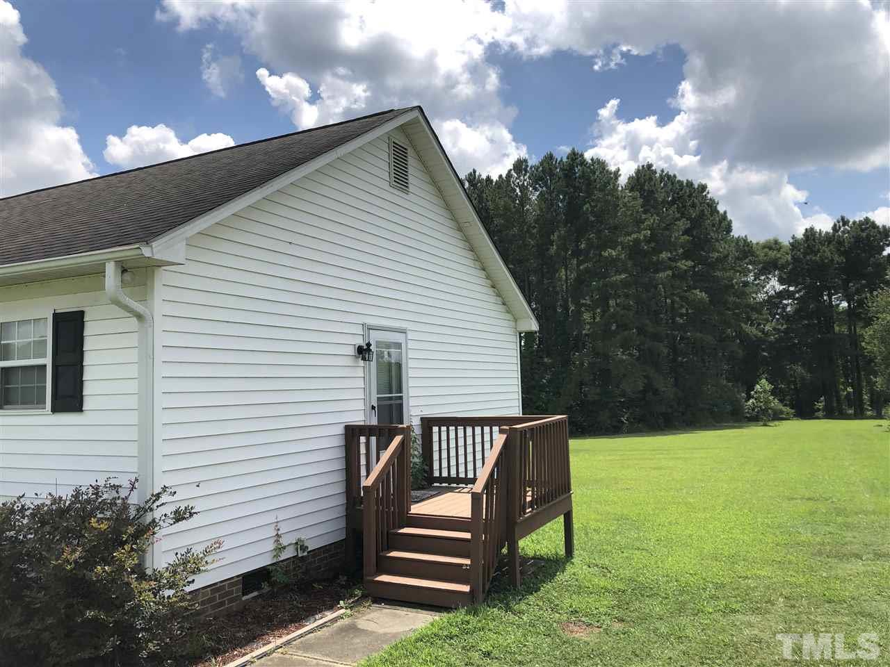 587 Rock Pillar Road Clayton, NC 27520 - Photo 5 of 12 a view of a wooden bench sitting in backyard of house