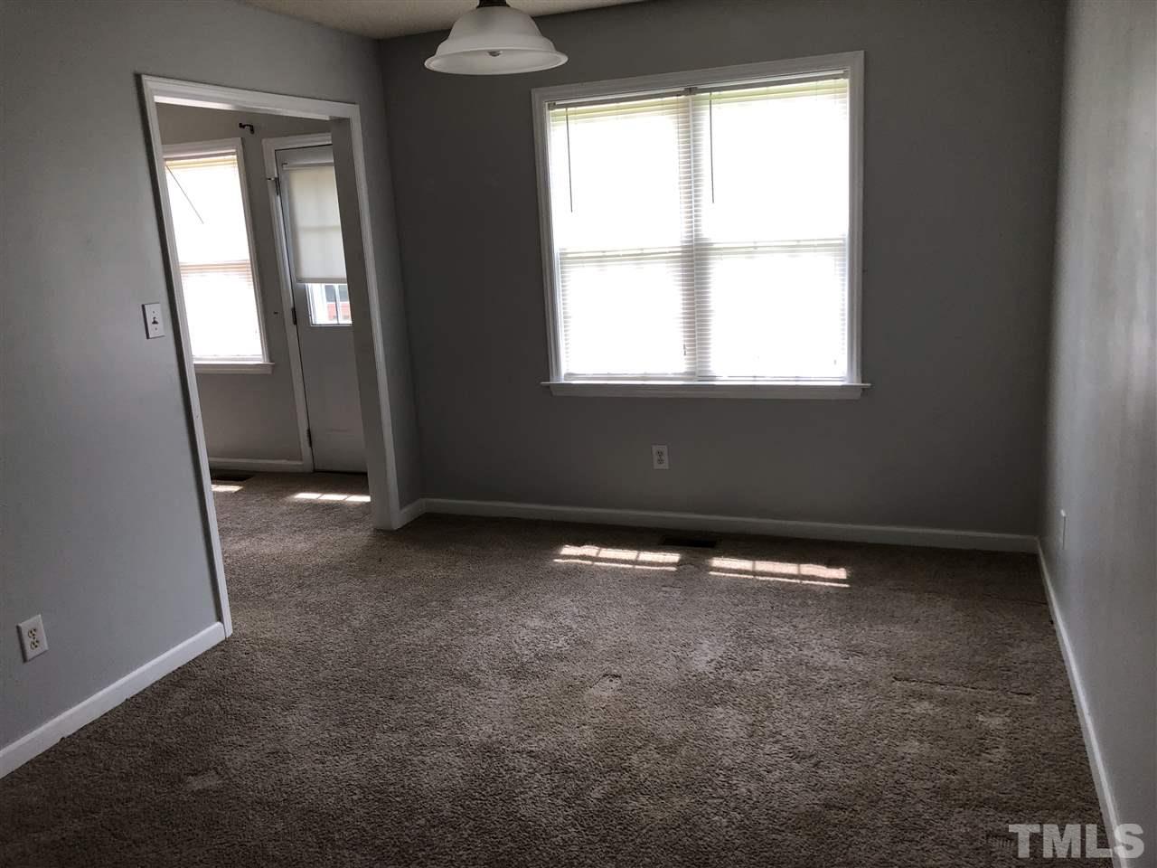 587 Rock Pillar Road Clayton, NC 27520 - Photo 7 of 12 an empty room with windows