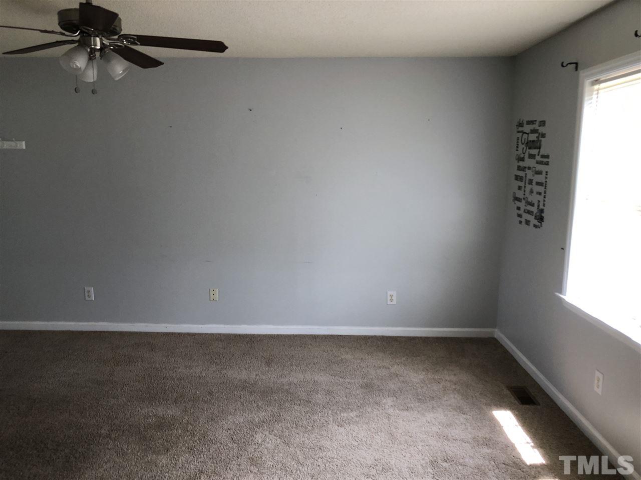 587 Rock Pillar Road Clayton, NC 27520 - Photo 8 of 12 a view of an empty room and a window