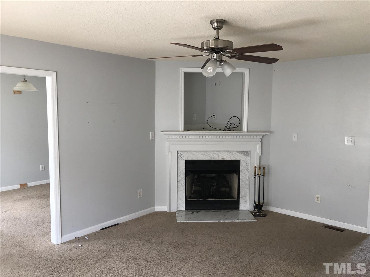 587 Rock Pillar Road Clayton, NC 27520 - Photo 9 of 12 a view of an empty room with a fireplace