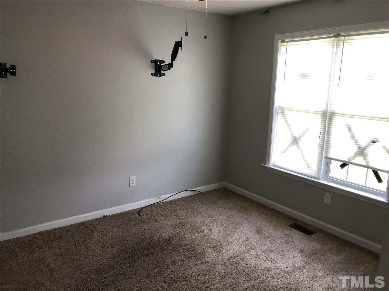 587 Rock Pillar Road Clayton, NC 27520 - Photo 10 of 12 an empty room with a window